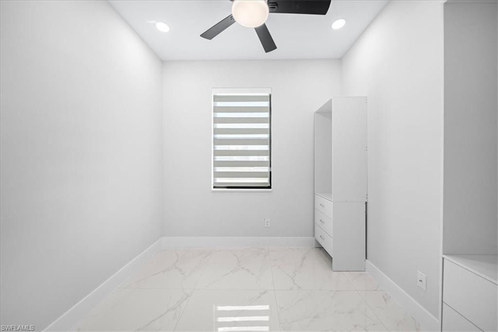 Full bath with a marble finish shower and light marble finish floors