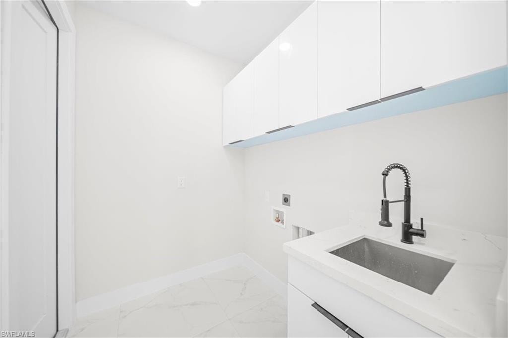 Walk in closet featuring light marble finish floors