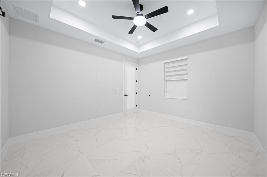 Spare room with recessed lighting, light marble finish floors, and ceiling fan