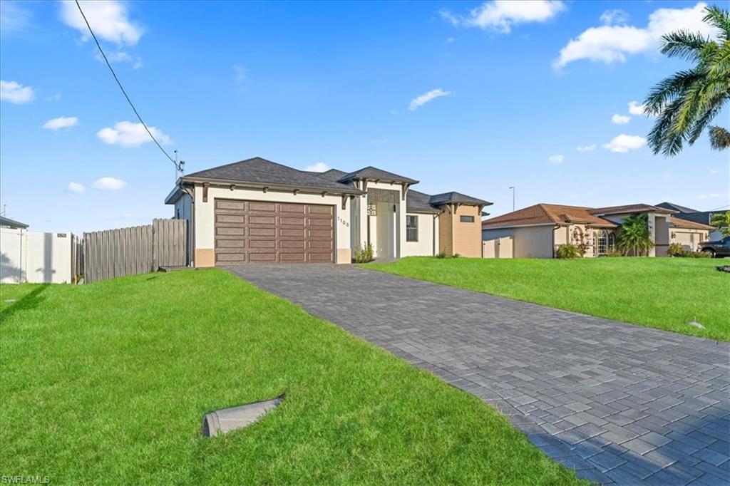 Back of house with a fenced backyard, a patio, and stucco siding
