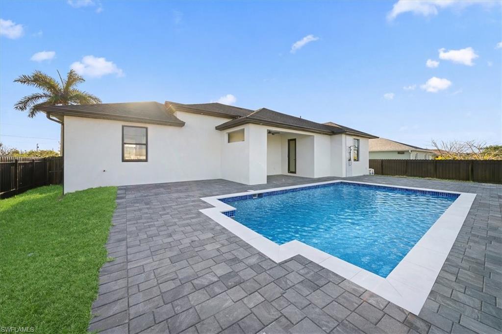 View of swimming pool featuring a fenced backyard and patio surround