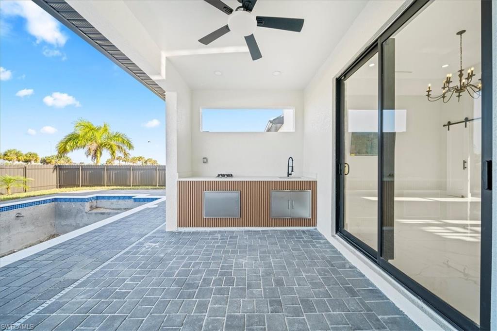 View of swimming pool with patio surround and a sink