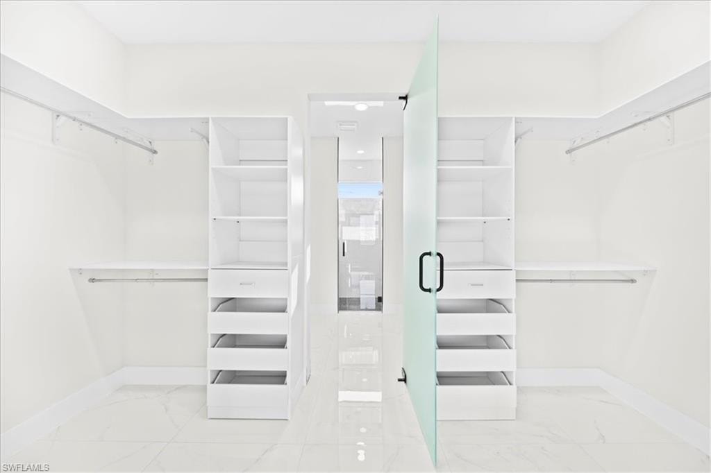 Unfurnished bedroom featuring recessed lighting, light marble finish floors, and ceiling fan