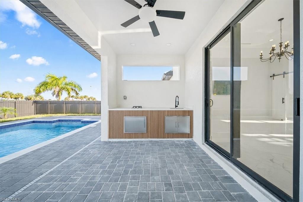View of pool with patio surround and a sink