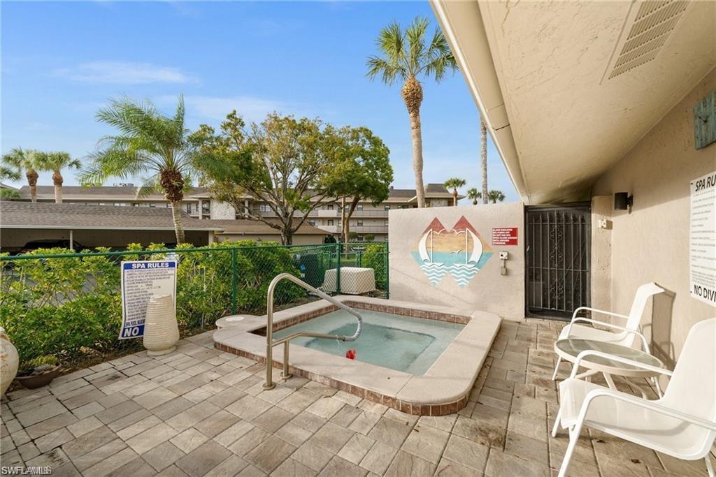 View of swimming pool with a community hot tub and a patio