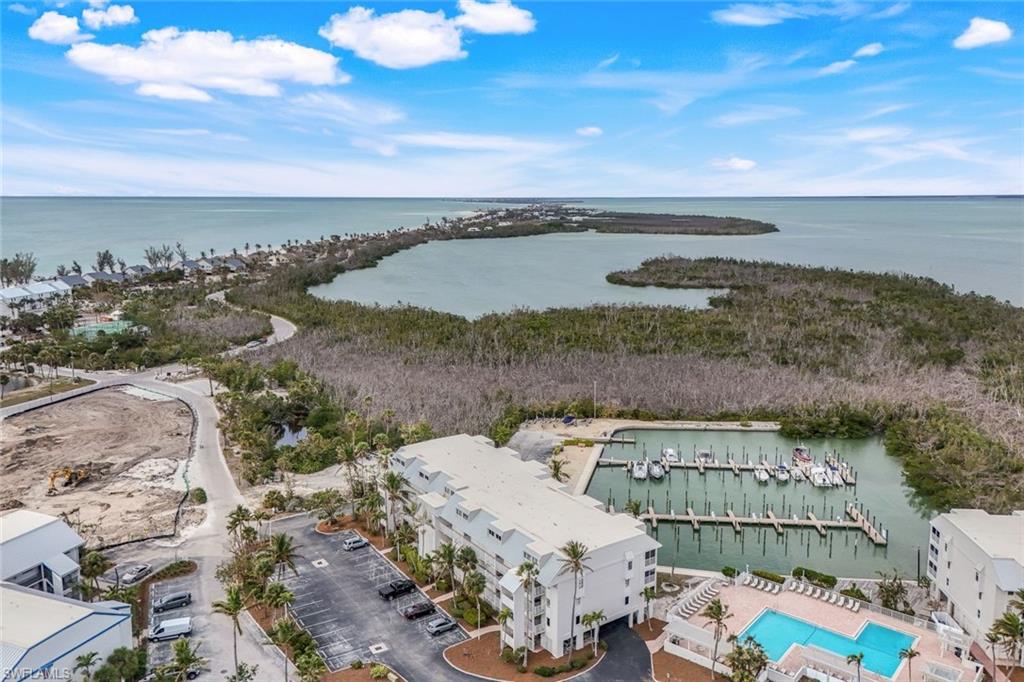 Birds eye view of property with a water view