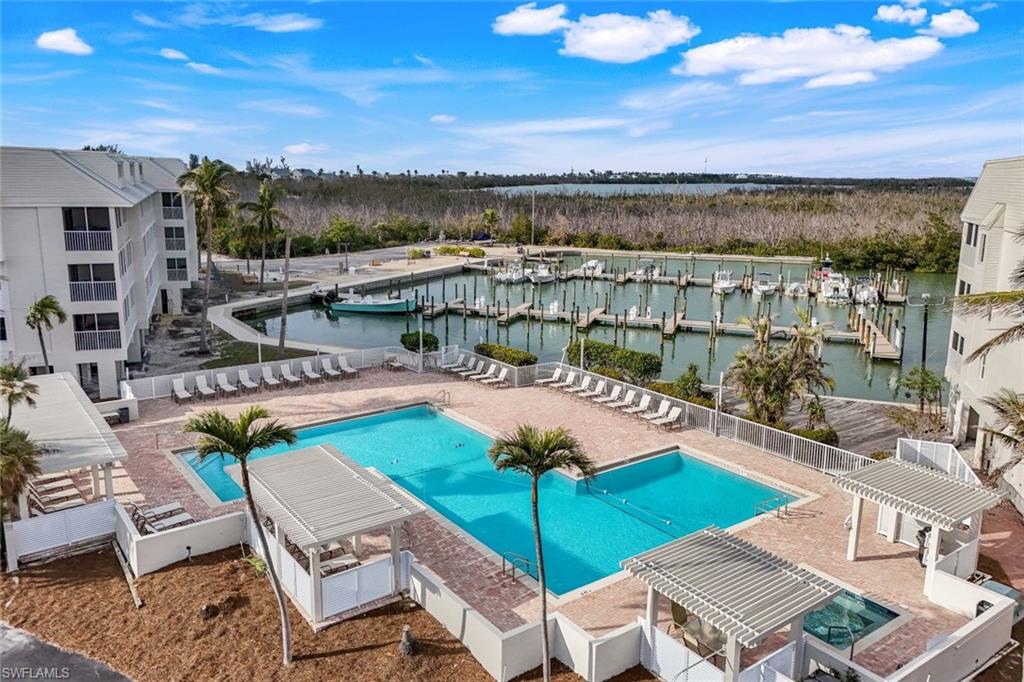 View of pool featuring a water view and a pergola