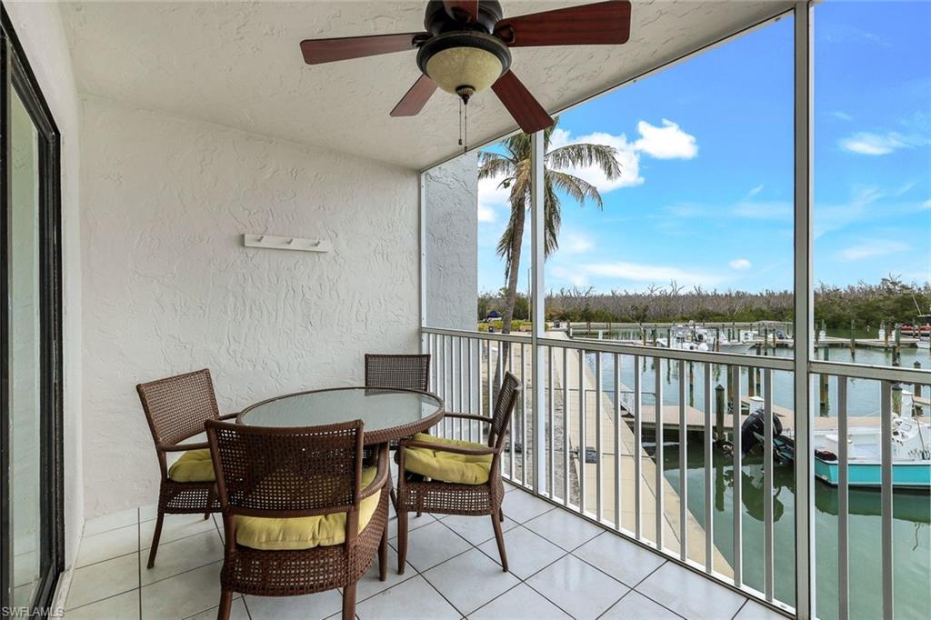 Balcony with a water view and ceiling fan