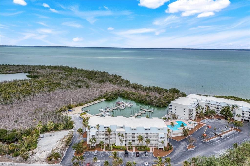 Birds eye view of property with a water view