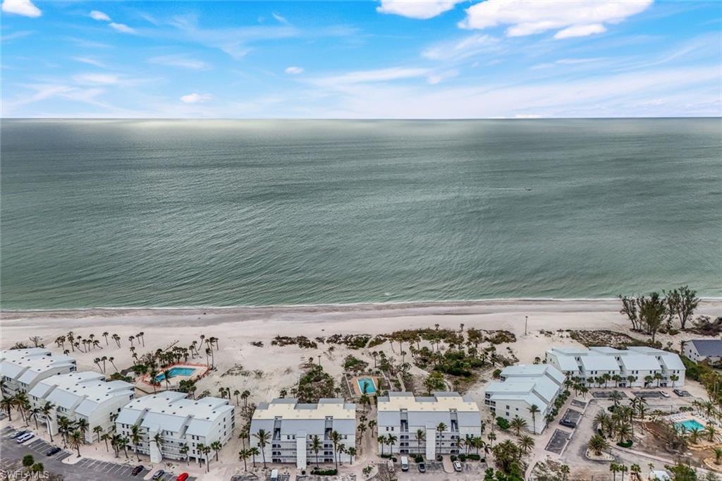 Aerial view with a water view and a beach view