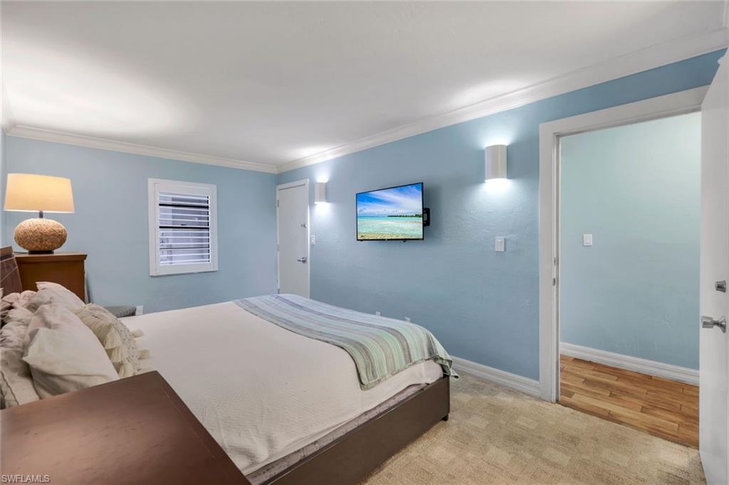 Carpeted bedroom with crown molding