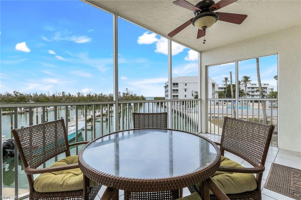 Sunroom / solarium with a water view and ceiling fan