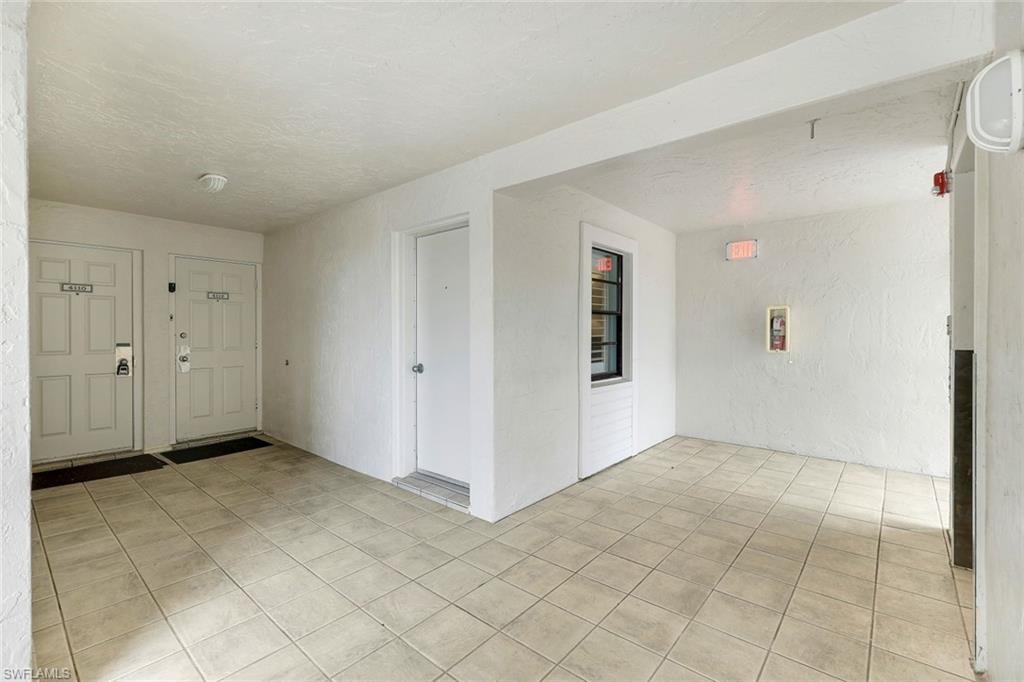 Foyer entrance featuring a textured ceiling and light tile patterned floors