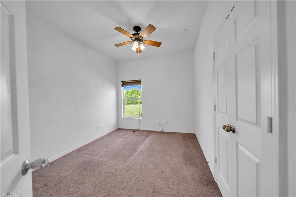 Unfurnished bedroom with carpet floors and ceiling fan