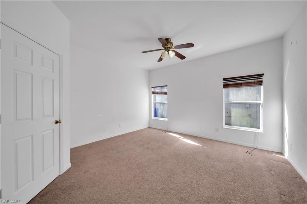 Unfurnished bedroom featuring carpet floors and ceiling fan
