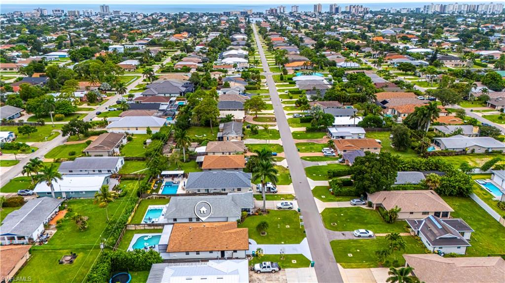 Aerial perspective of suburban area featuring skyline and a nearby body of water