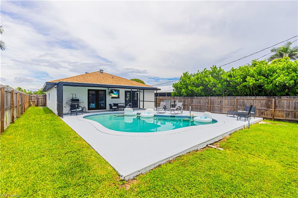 View of swimming pool featuring a patio, a fenced backyard, and french doors