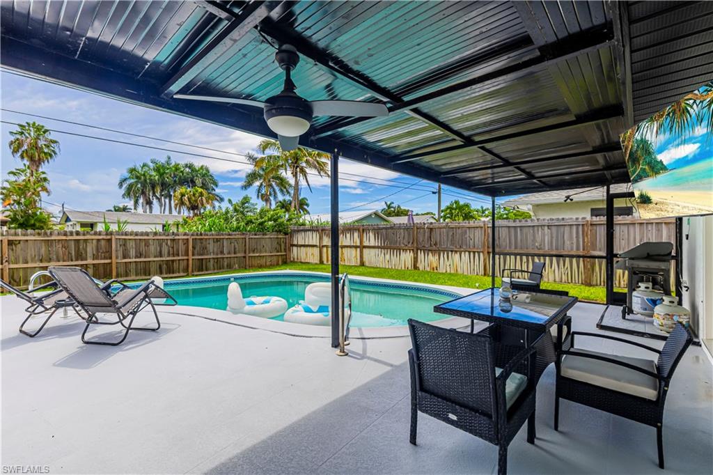 View of swimming pool featuring a patio, a fenced backyard, and grilling area