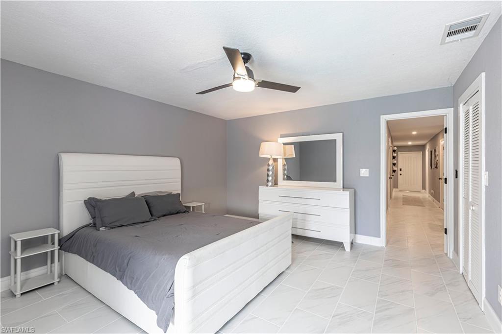 Bedroom with ceiling fan and baseboards