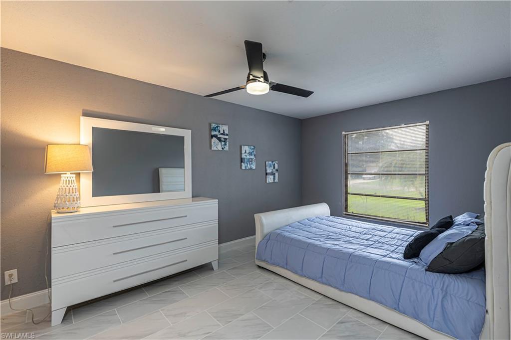 Bedroom featuring ceiling fan and baseboards