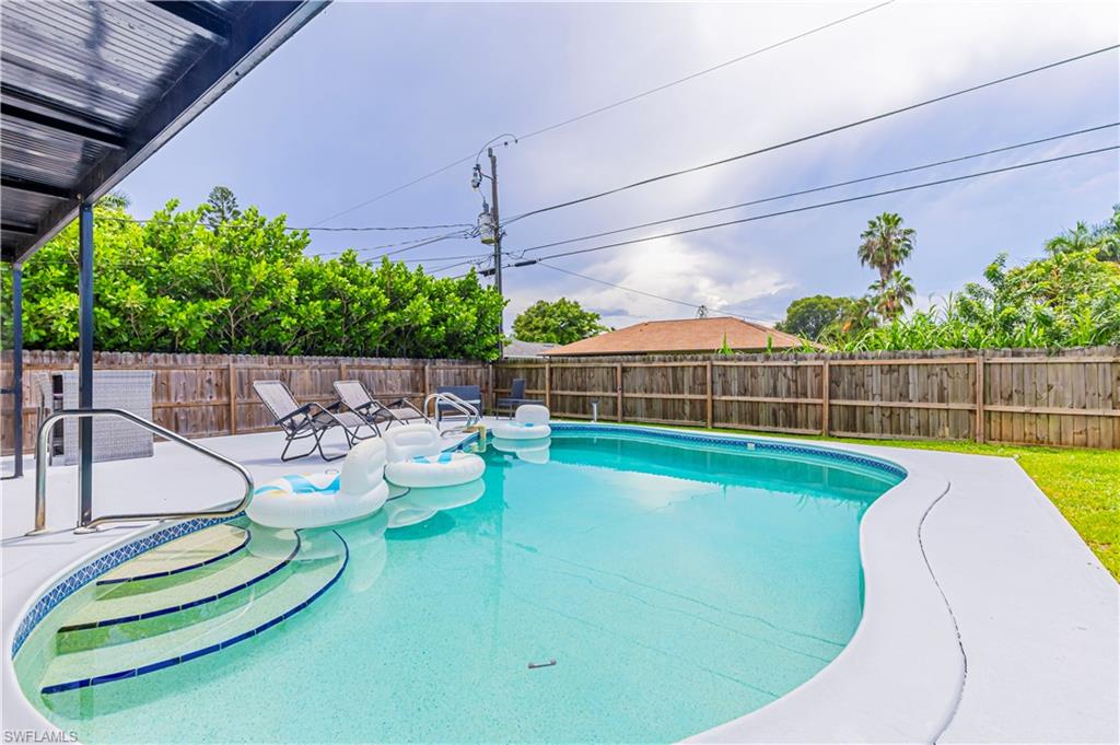 View of pool with a patio and a fenced backyard