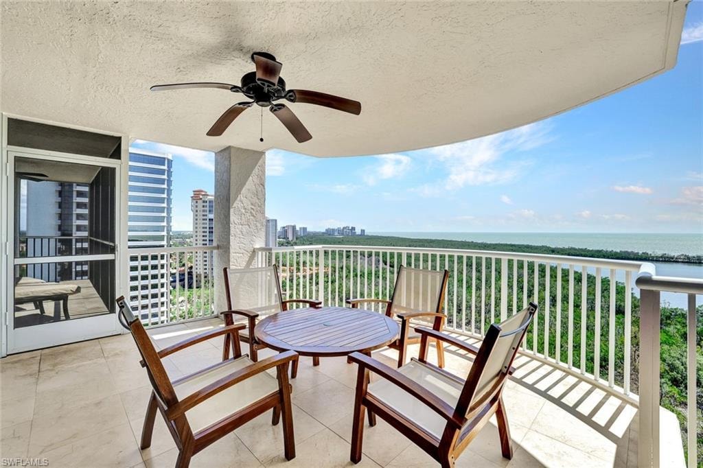 Balcony with a water view and ceiling fan