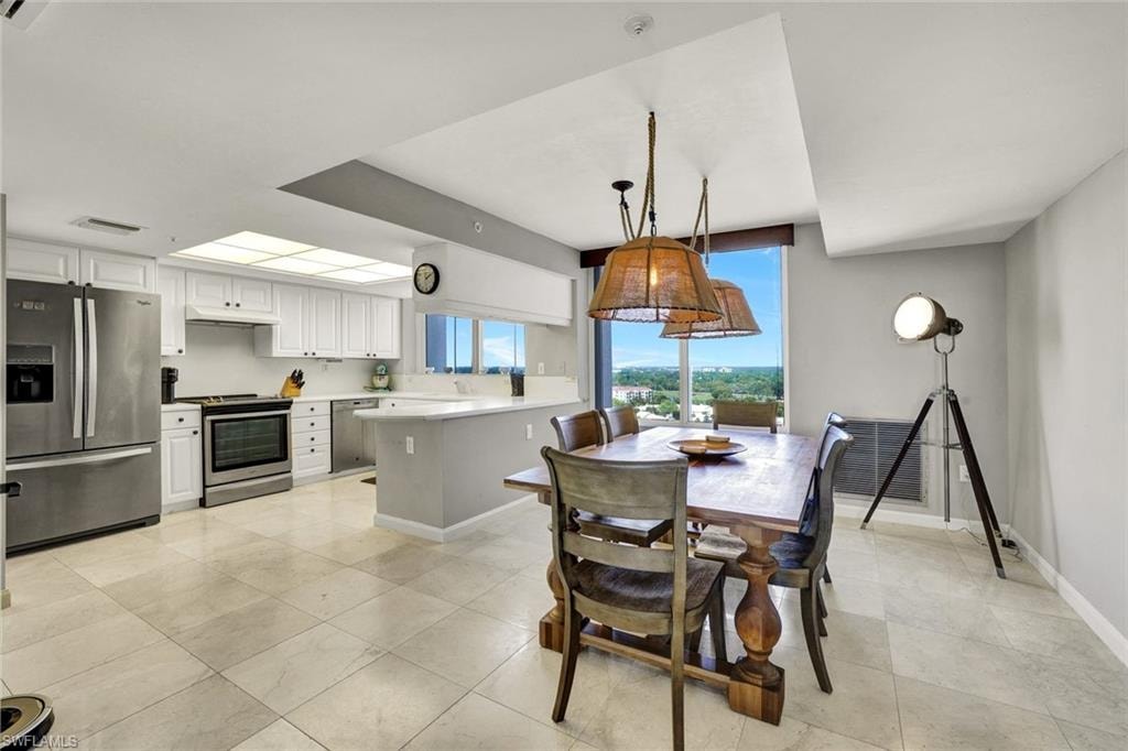 Dining room featuring visible vents, baseboards, and light tile patterned floors