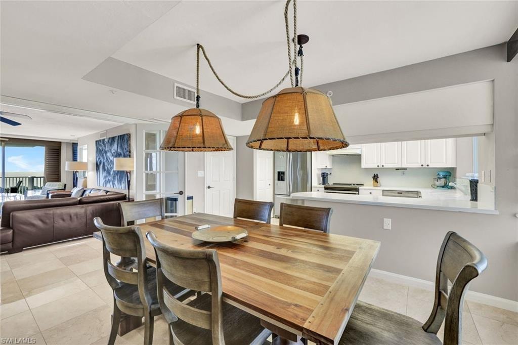 Dining room featuring visible vents, baseboards, a ceiling fan, and light tile patterned floors