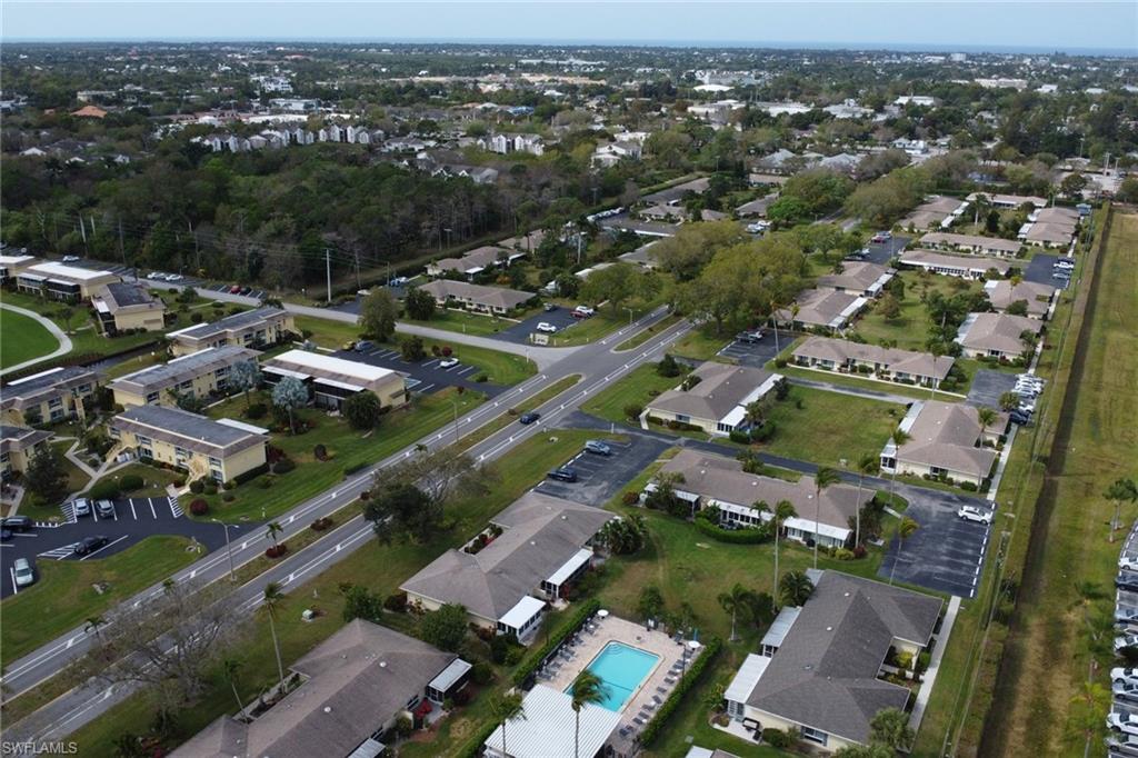 Aerial view of property and surrounding area with nearby suburban area