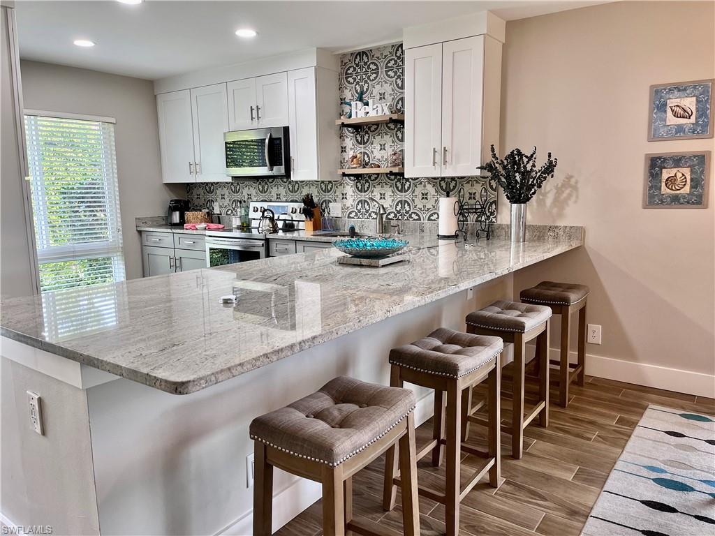 Large Chef Kitchen with bar area that has USB/Electrical Outlets for working