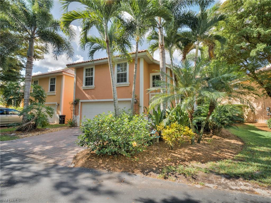 View of front of home with stucco siding, decorative driveway, a garage, and a tile roof