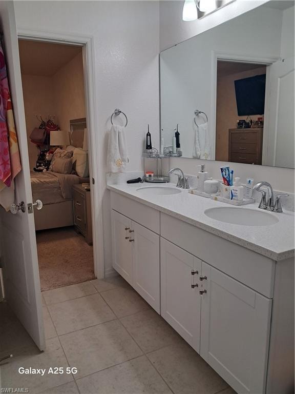 Master bathroom with tile patterned flooring and vanity