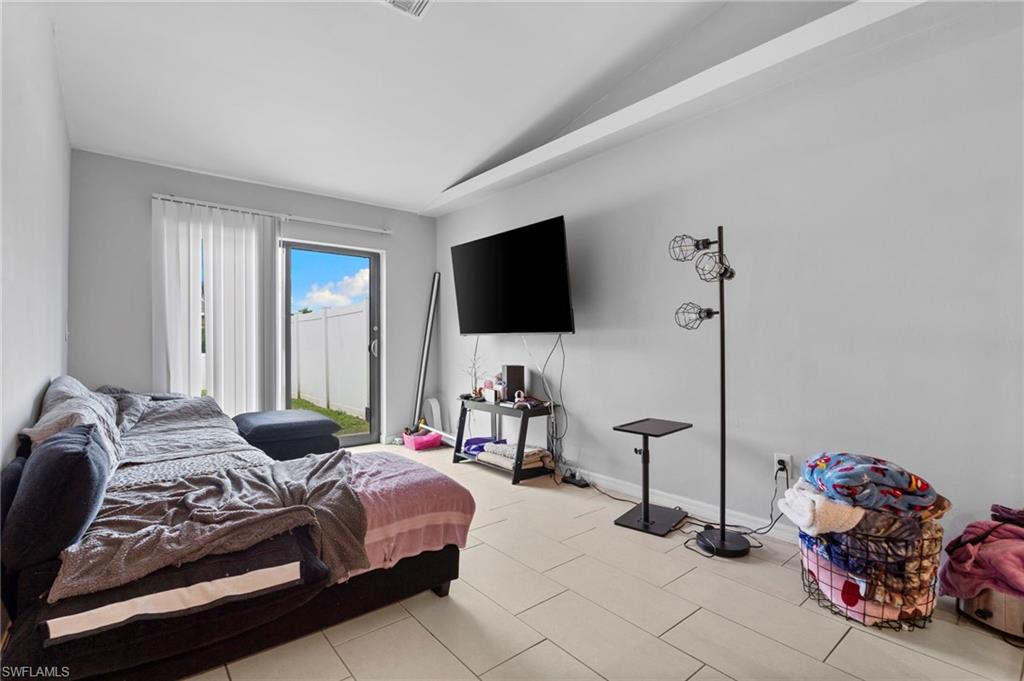Bedroom featuring vaulted ceiling and baseboards