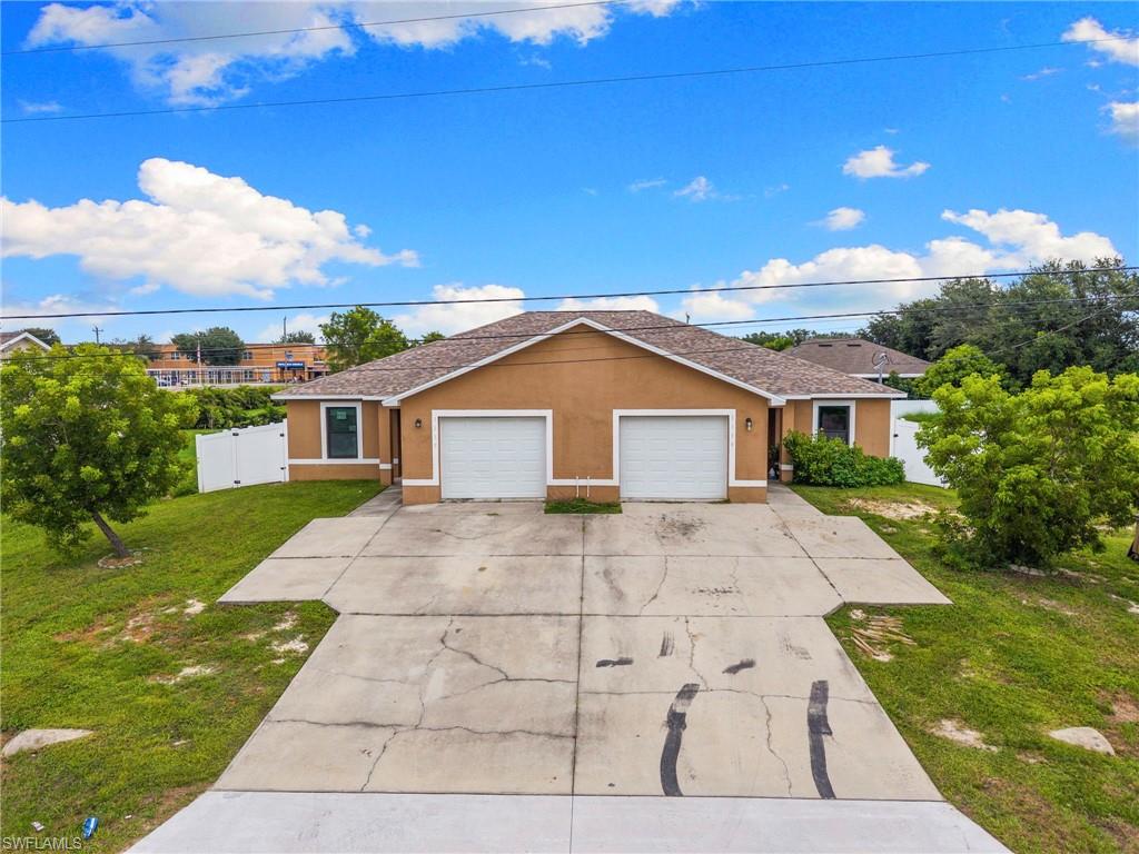 Ranch-style home with stucco siding, concrete driveway, and an attached garage