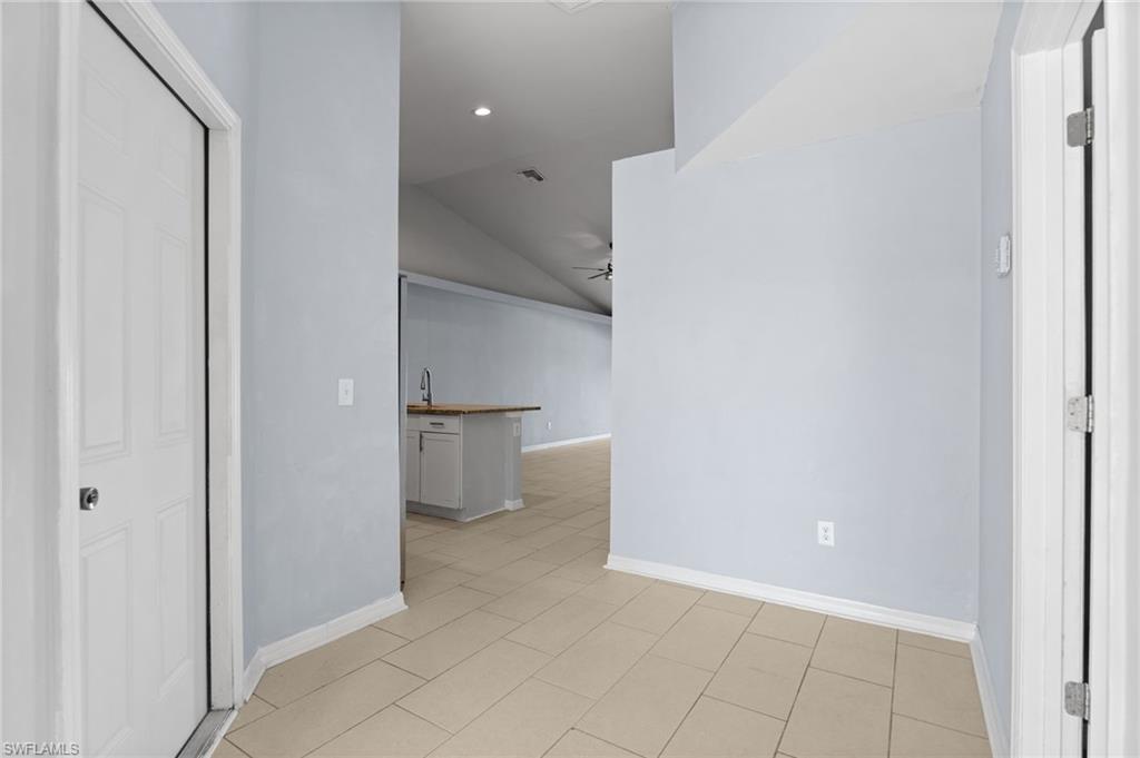 Hall featuring lofted ceiling and recessed lighting