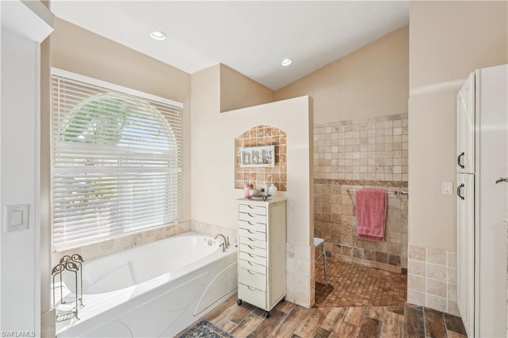 Bathroom featuring a garden tub and wood tiled floors