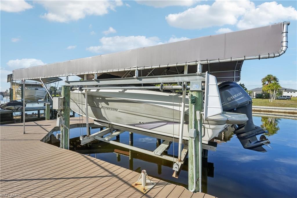 Dock with boat lift and a water view