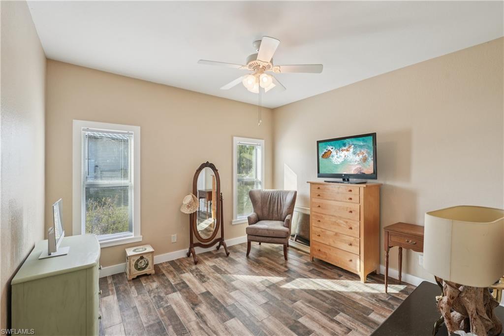 Sitting room with wood finished floors and ceiling fan