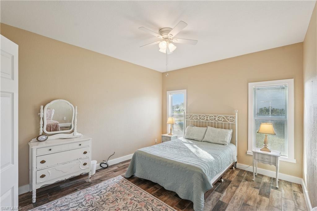 Bedroom with wood finished floors and ceiling fan