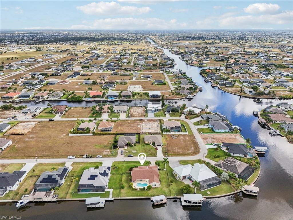 Aerial view of property's location with nearby suburban area and a large body of water