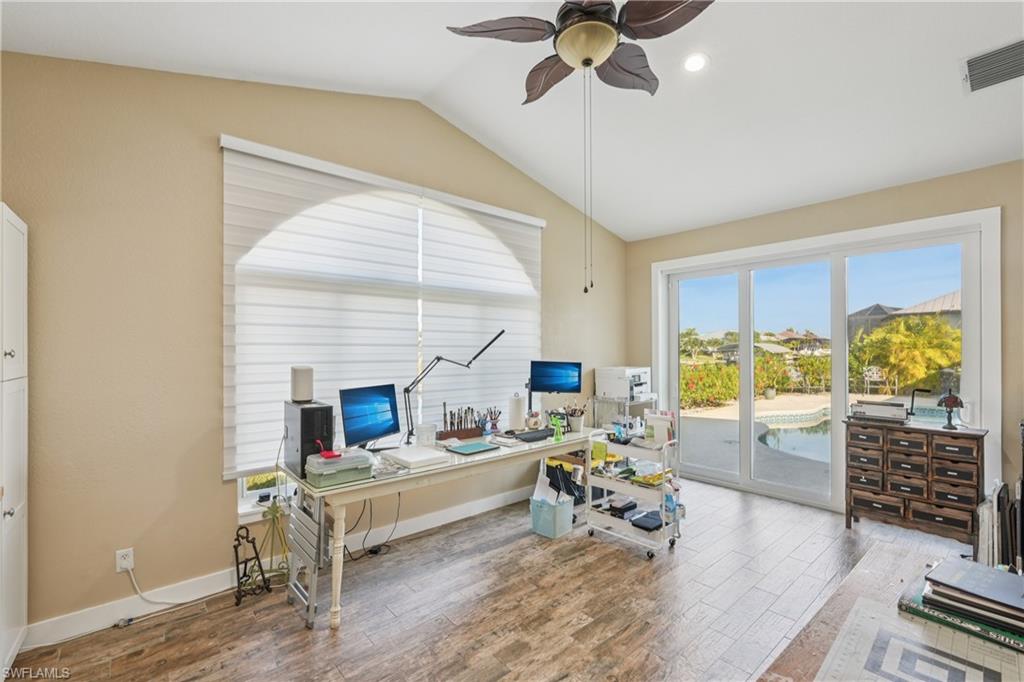 Office area with lofted ceiling, wood finished floors, and ceiling fan