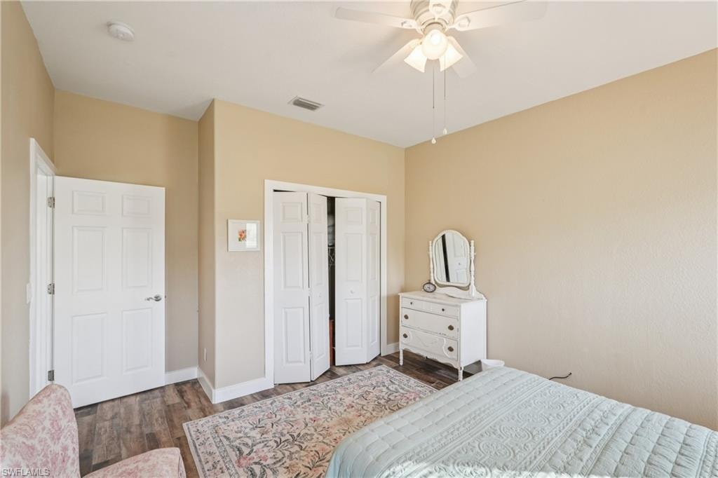 Bedroom featuring a closet, ceiling fan, and dark wood finished floors