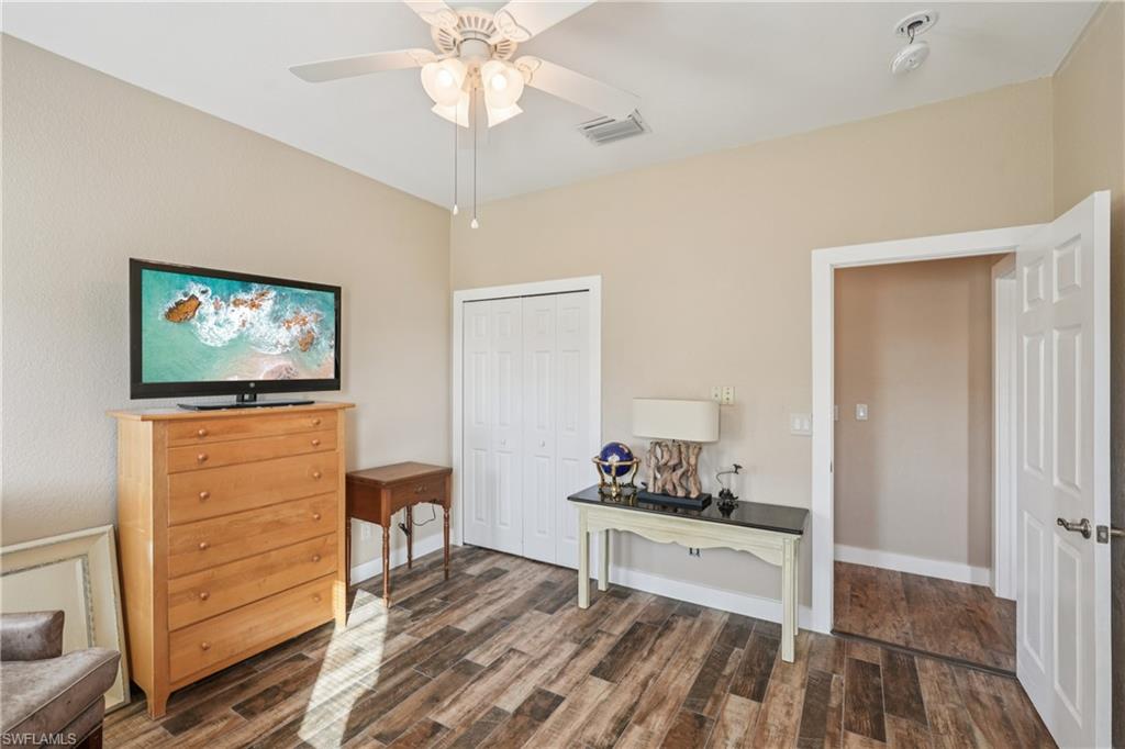 Office space featuring dark wood-style floors and ceiling fan