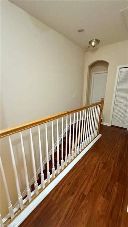 Staircase featuring wood finished floors