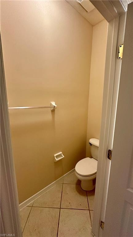 Bathroom featuring light tile patterned floors and toilet