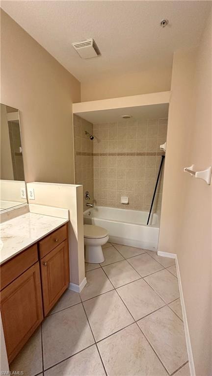 Full bath featuring vanity, shower / bath combination, light tile patterned floors, and a textured ceiling