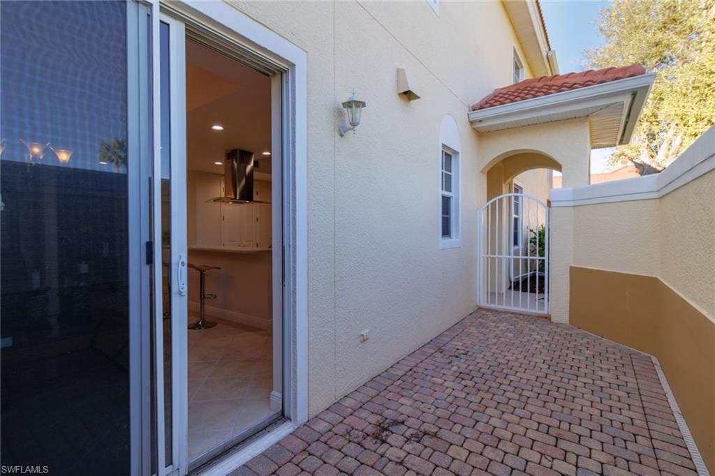 Courtyard patio with gate to front entry