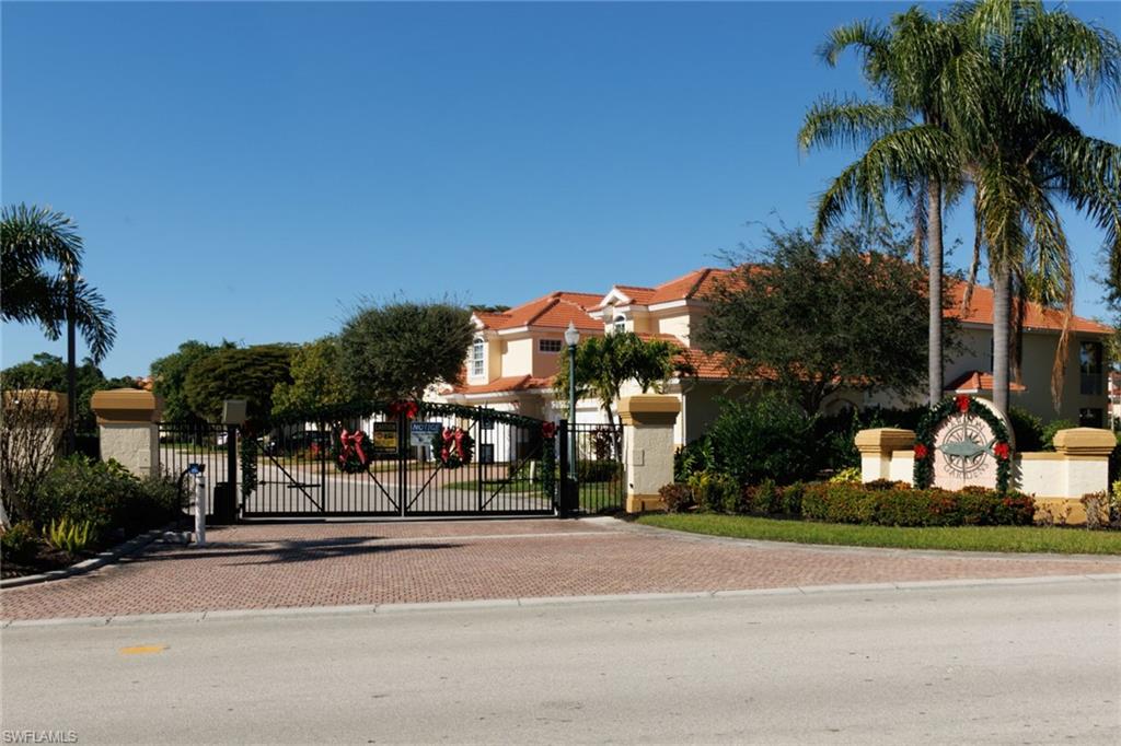 Gated entrance to Tarpon Gardens decorated for holiday season.