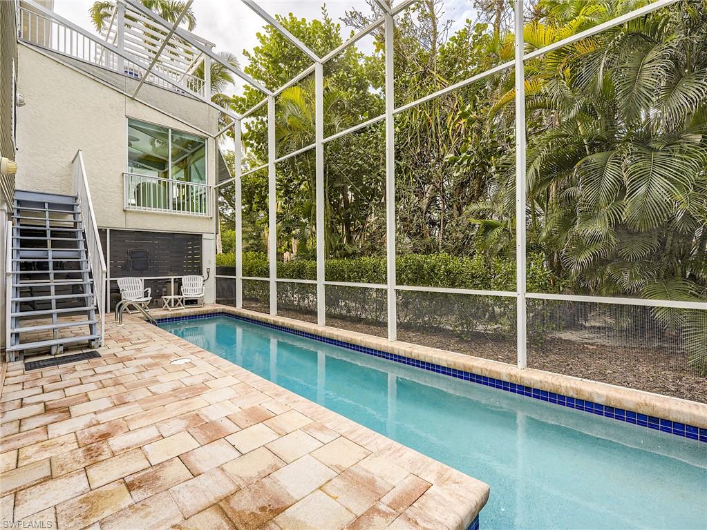 Windows in living room overlook the pool