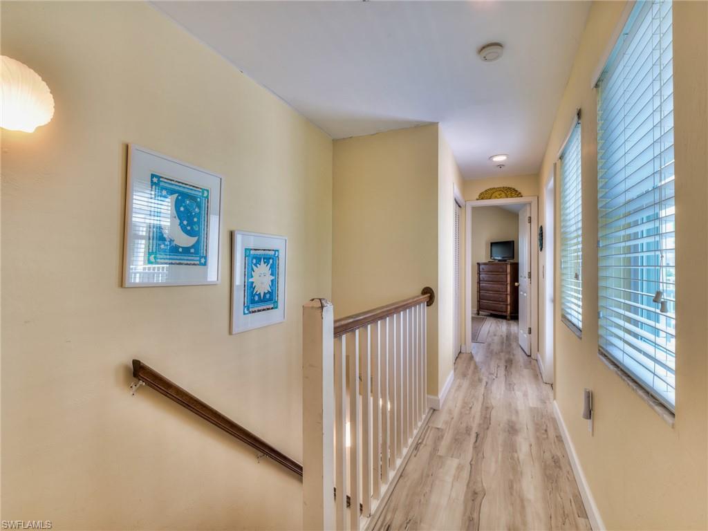 Stairs from 1st floor lead to hallway separating the w 2nd floor bedrooms and sun deck
